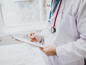 Physician noting down symptoms of a patient